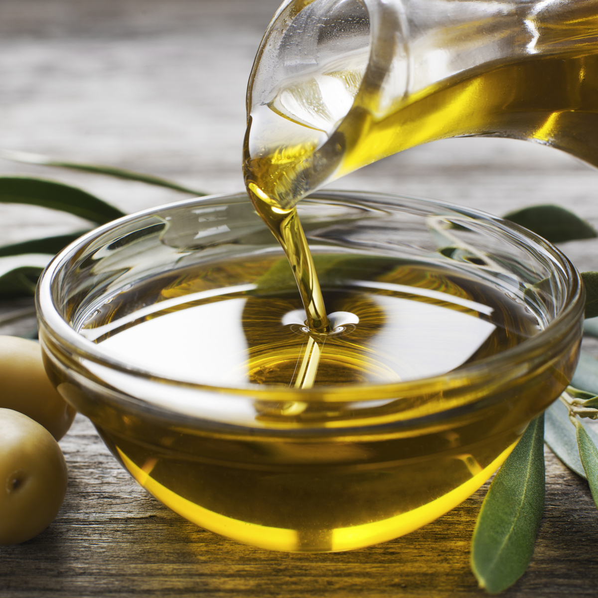 olive oil pouring into small bowl