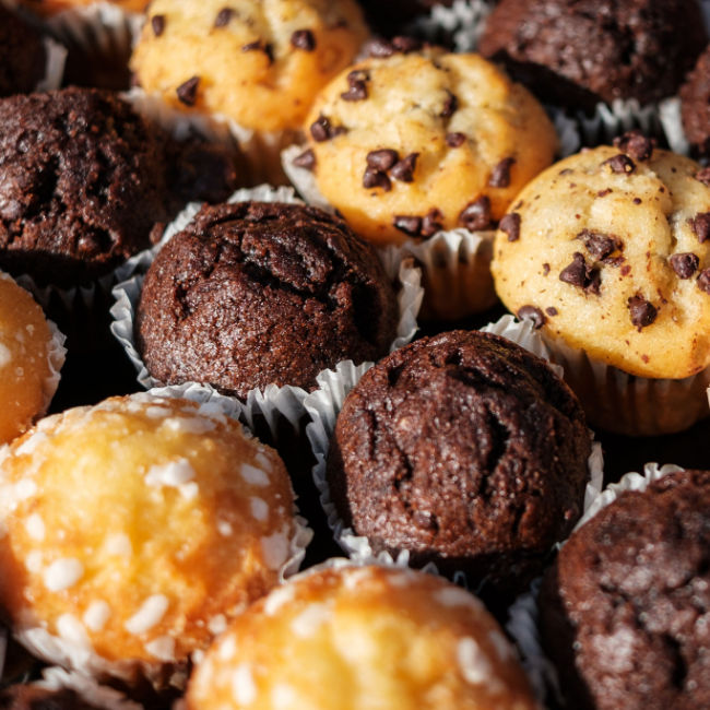 rows of different flavored muffins