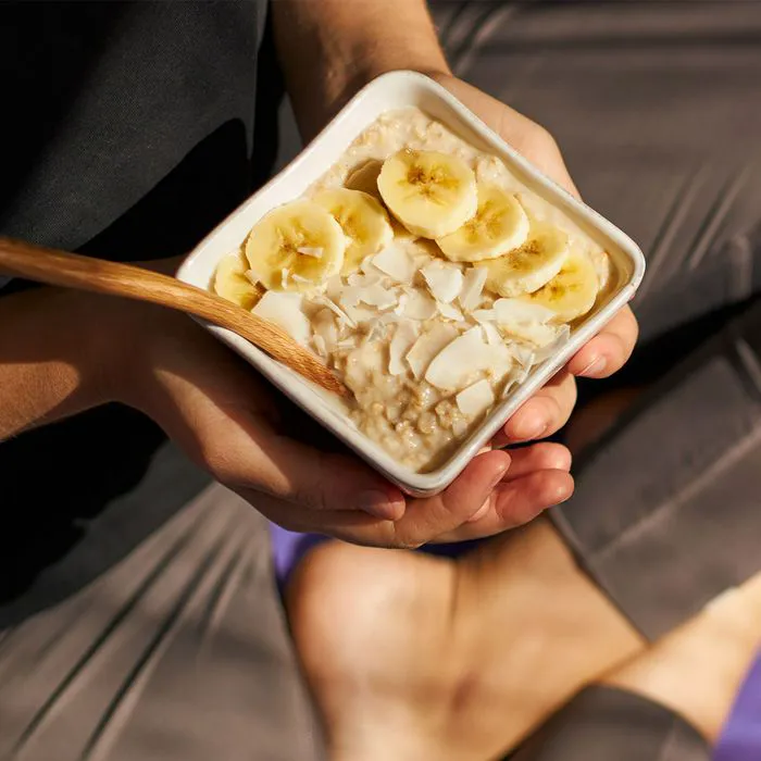 Yogi holding a bowl of delicious banana oatmeal.