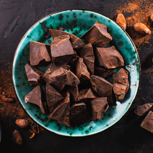 pieces of crumbled dark chocolate in blue bowl