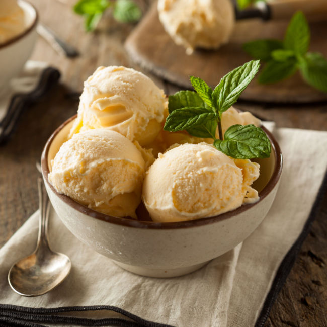 vanilla ice cream in bowl with mint leaves