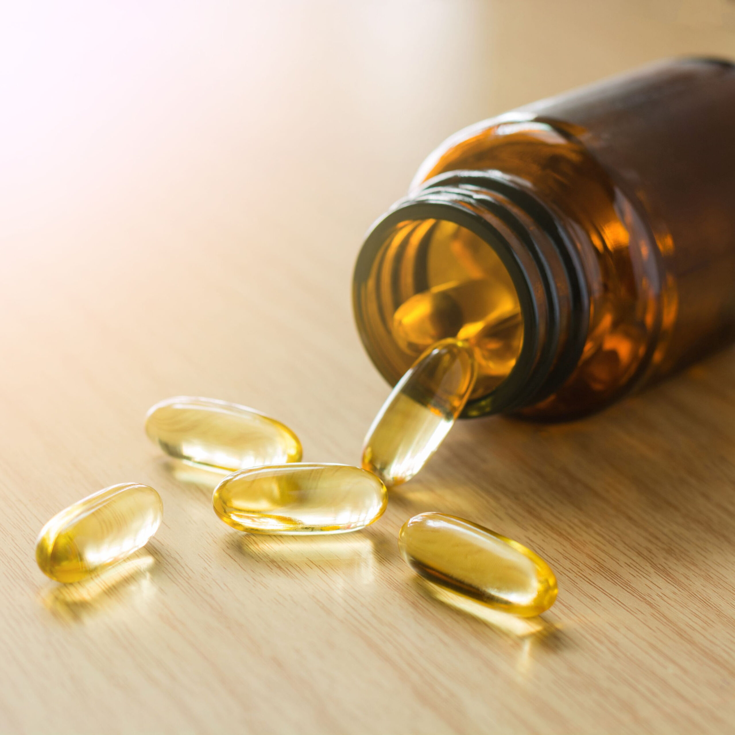 omega-3 supplements spilling out of bottle