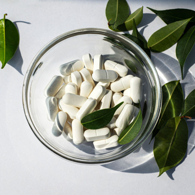 magnesium pills in small glass dish