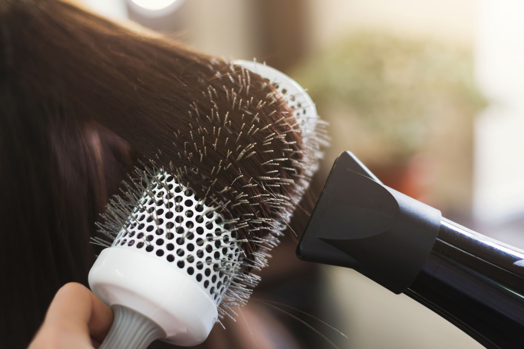 Person drying their hair.