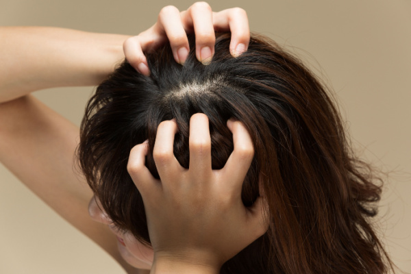 Person massaging their scalp.