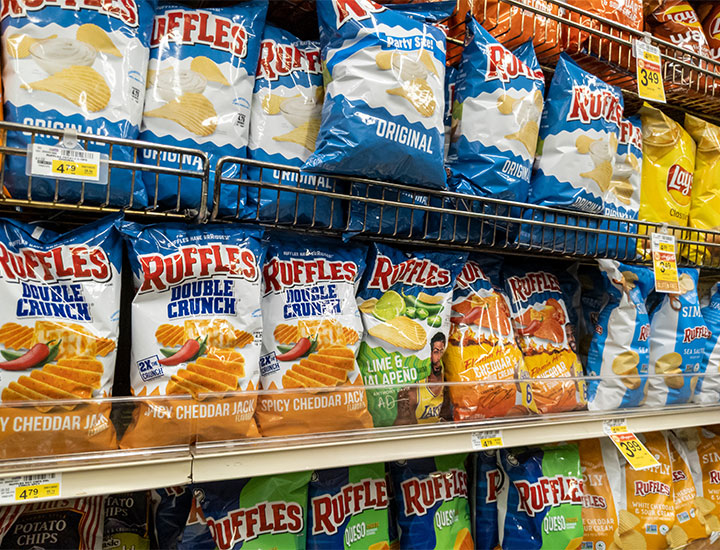 Bags of potato chips in the grocery store.