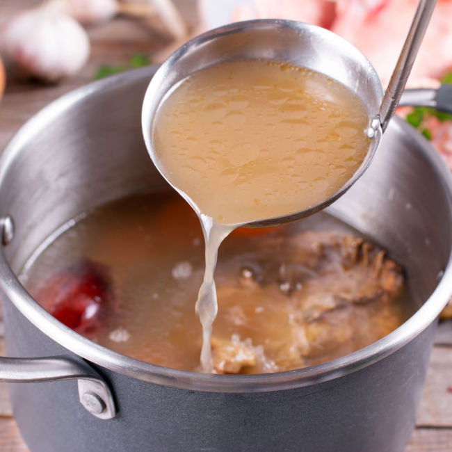 pot of beef bone broth cooking