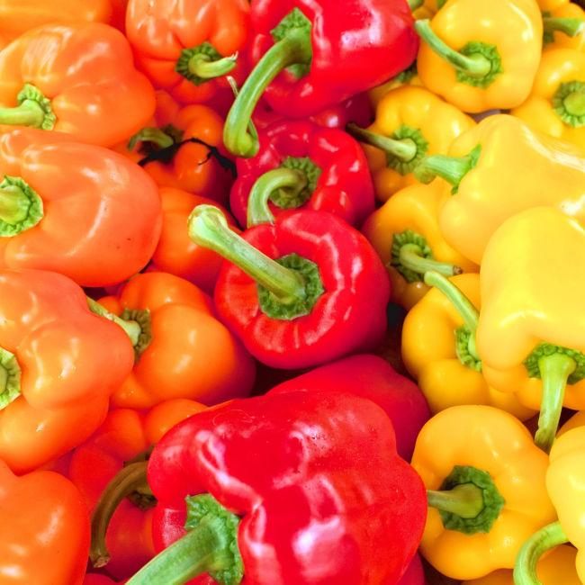 display of orange, red, and yellow bell peppers