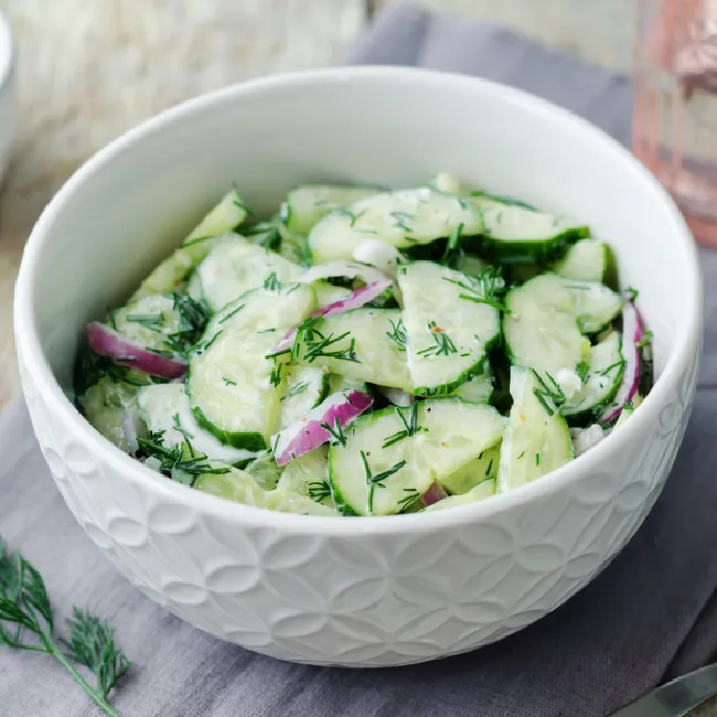 Fresh cucumber salad with vibrant vegetables and dressing.