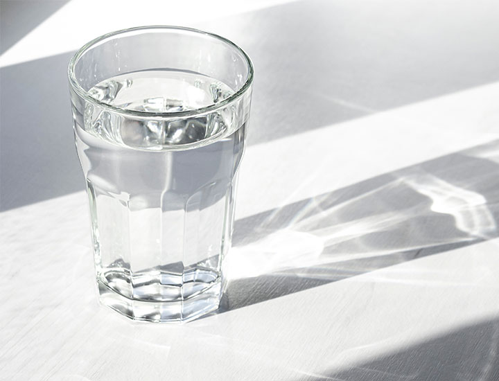Glass of water on a table.