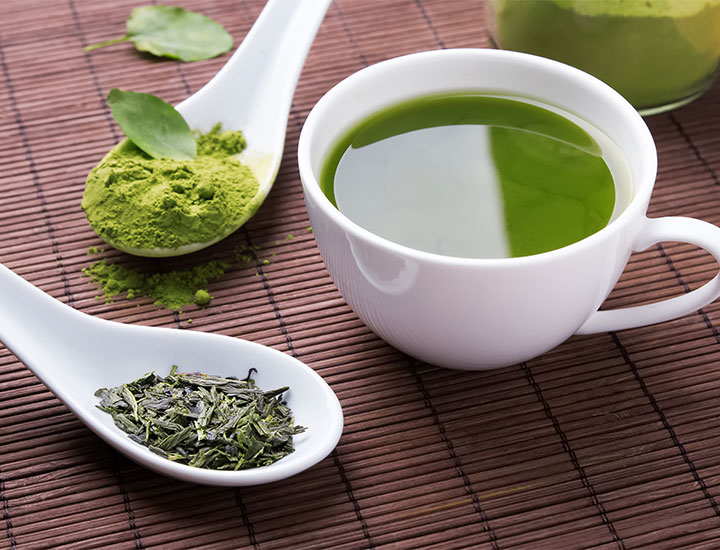 Cup of green tea on a table.