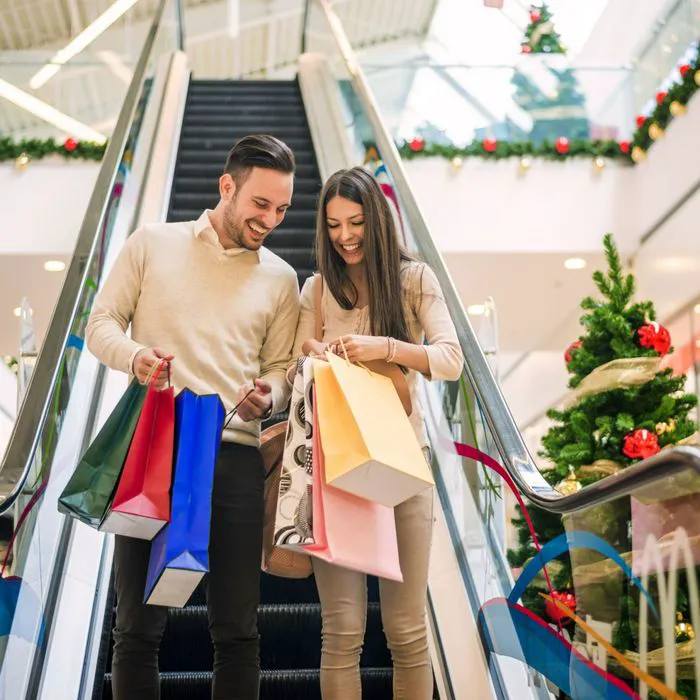 Holiday shoppers enjoying festive decorations in a mall