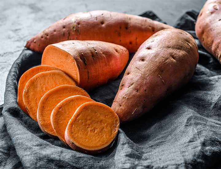 Plate of sweet potatoes on a table.