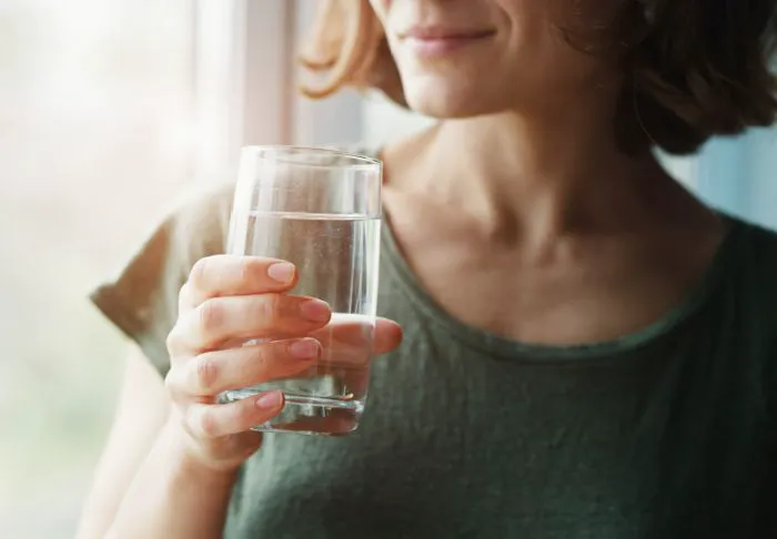 Woman drinking water.