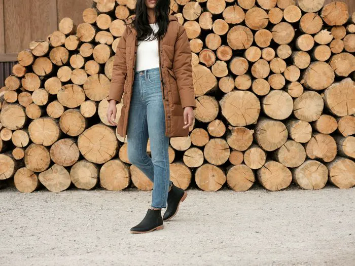 Black Chelsea boots featured in Fall 2021 campaign.