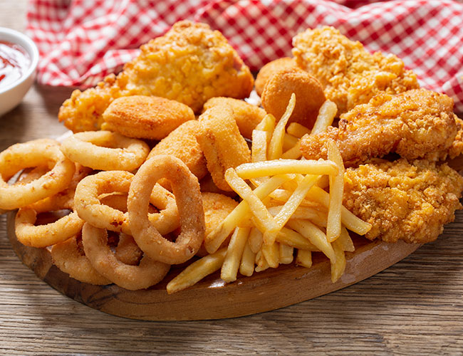 various fried foods like chicken, fries, and onion rings