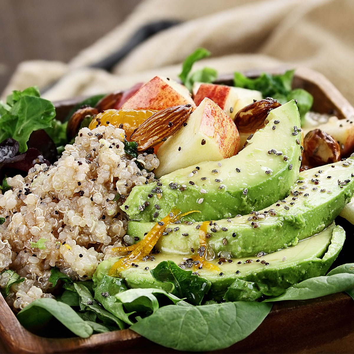 healthy salad with apples, avocado, quinoa, and chia seeds