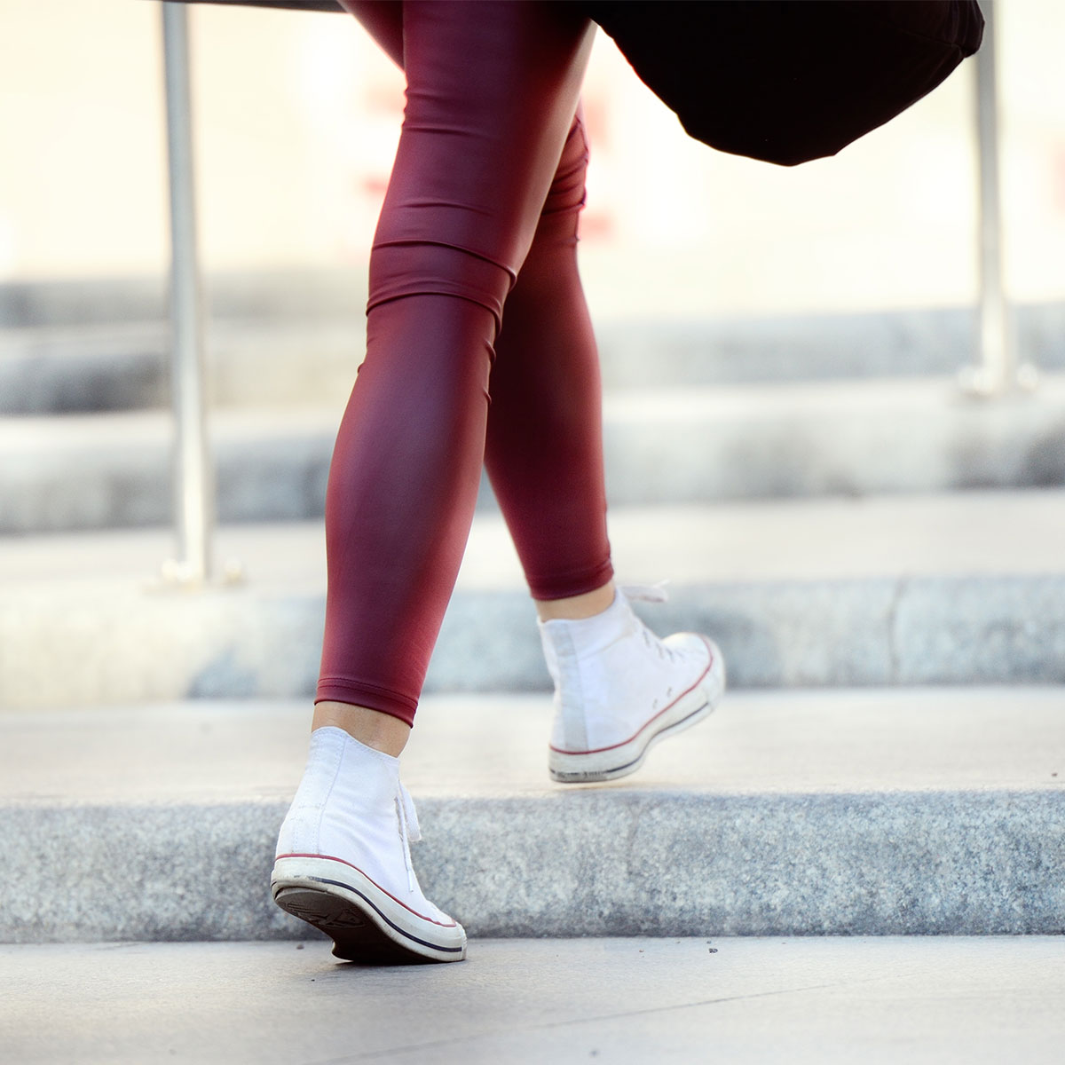 woman's legs walking up stairs outdoors