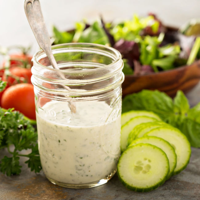 jar of ranch dressing beside salad ingredients