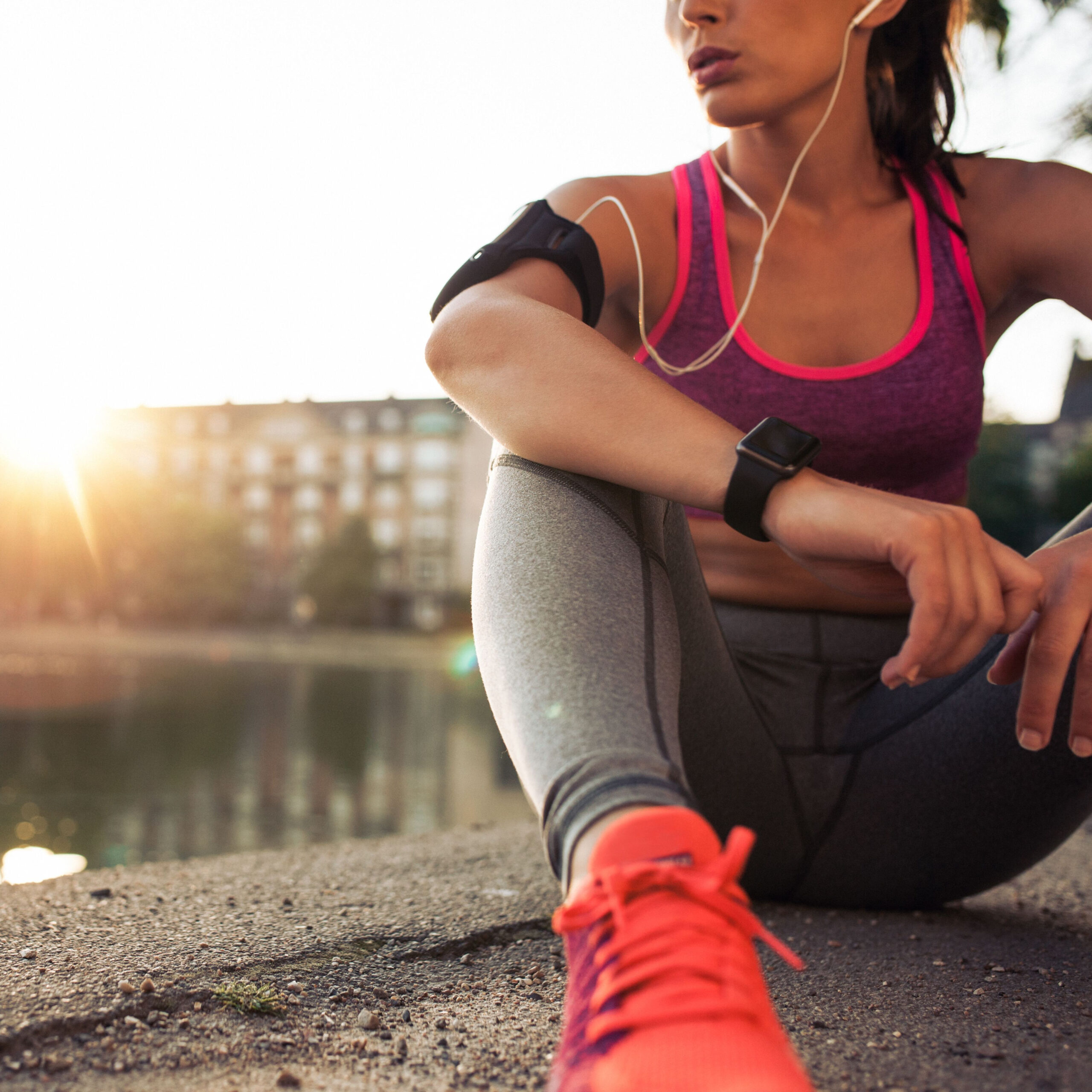 woman sitting down and taking a break from running