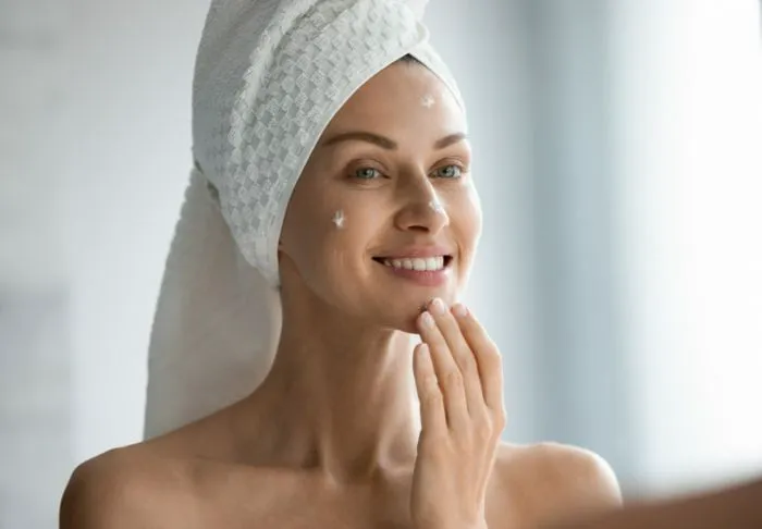 Woman cleaning face.