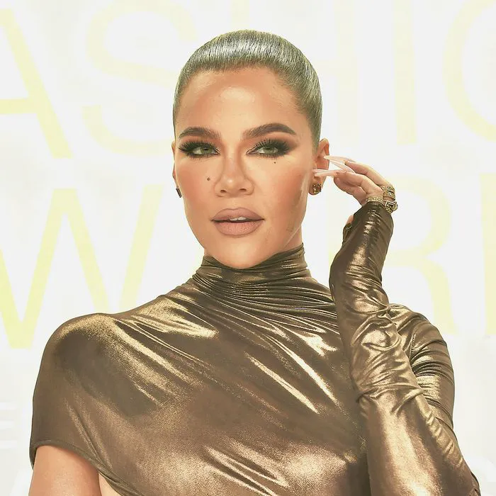Khloe Kardashian posing confidently in stylish outfit