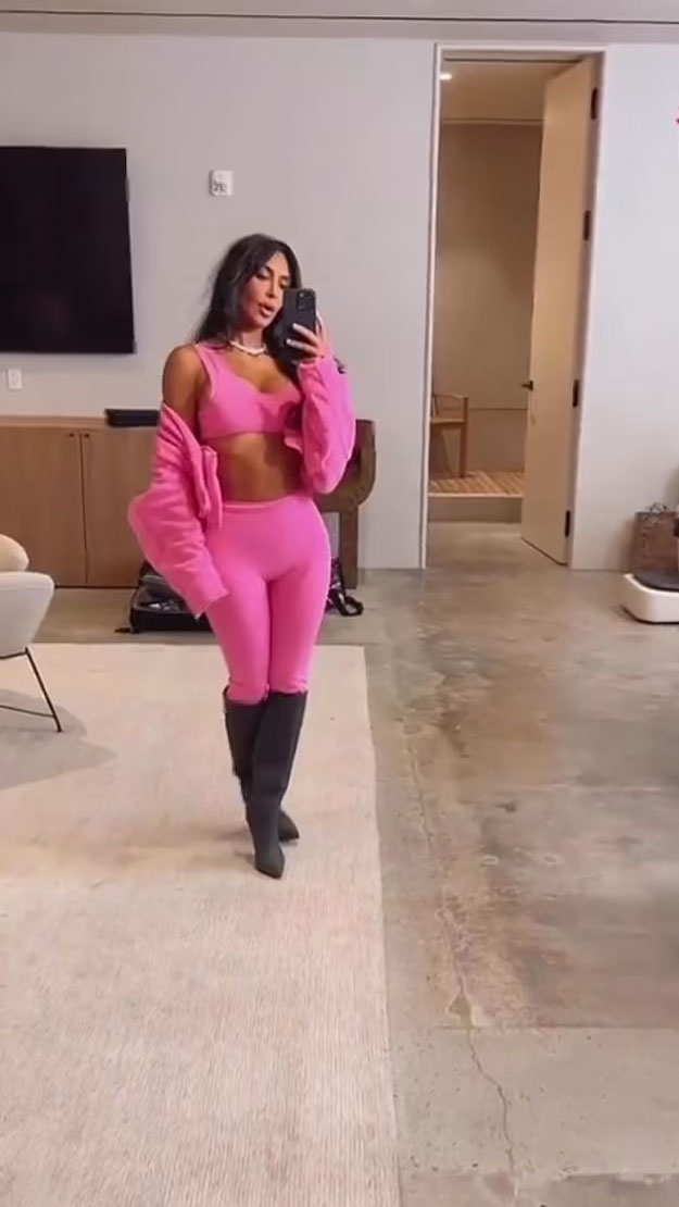 Kim Kardashian wearing skims pink pajamas click to shop