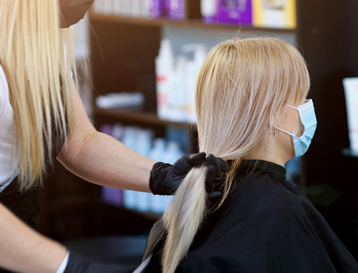 Woman getting a haircut.