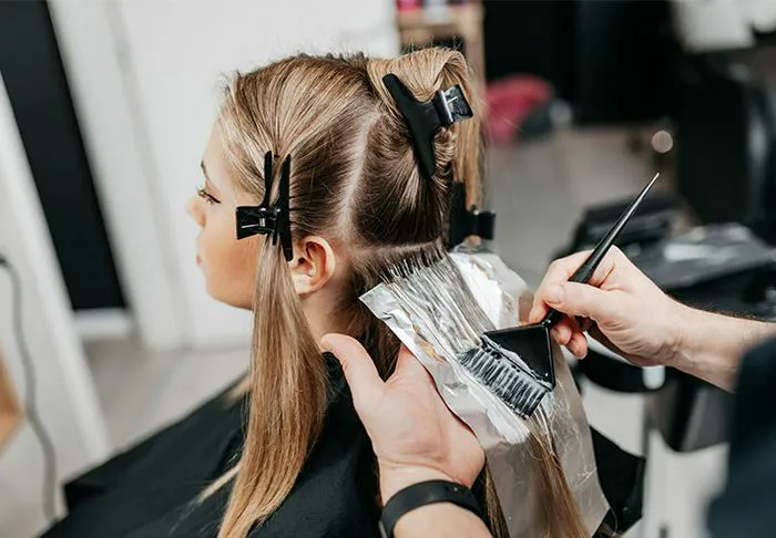 Woman getting her hair dyed.