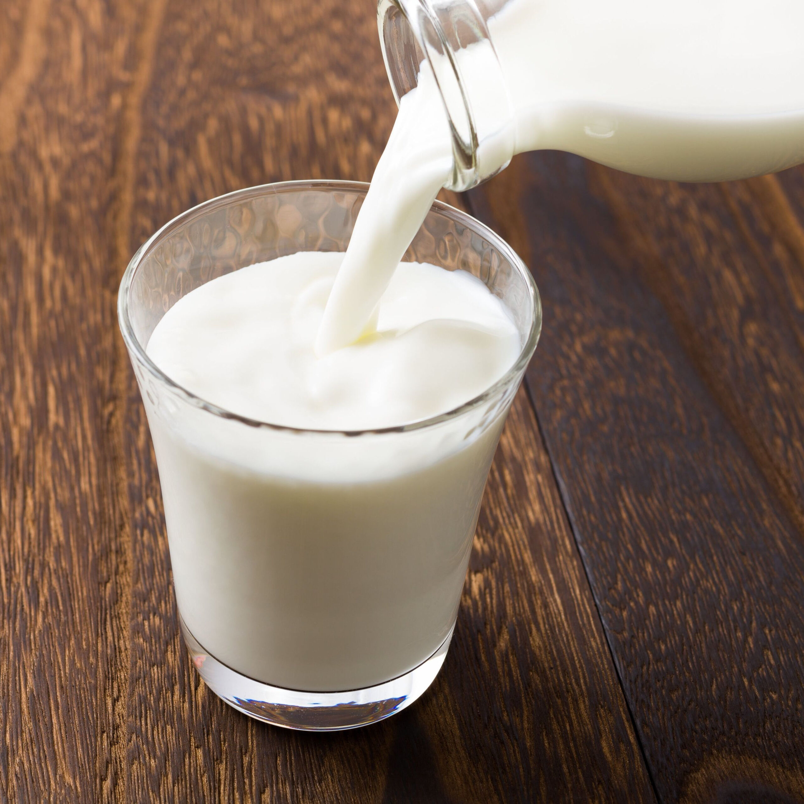 whole milk pouring into glass