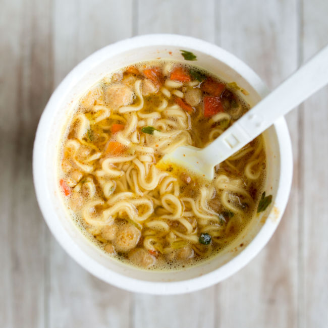 cup of cooked ramen noodles with plastic fork