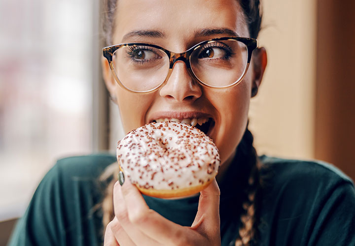 Woman eating a donut.