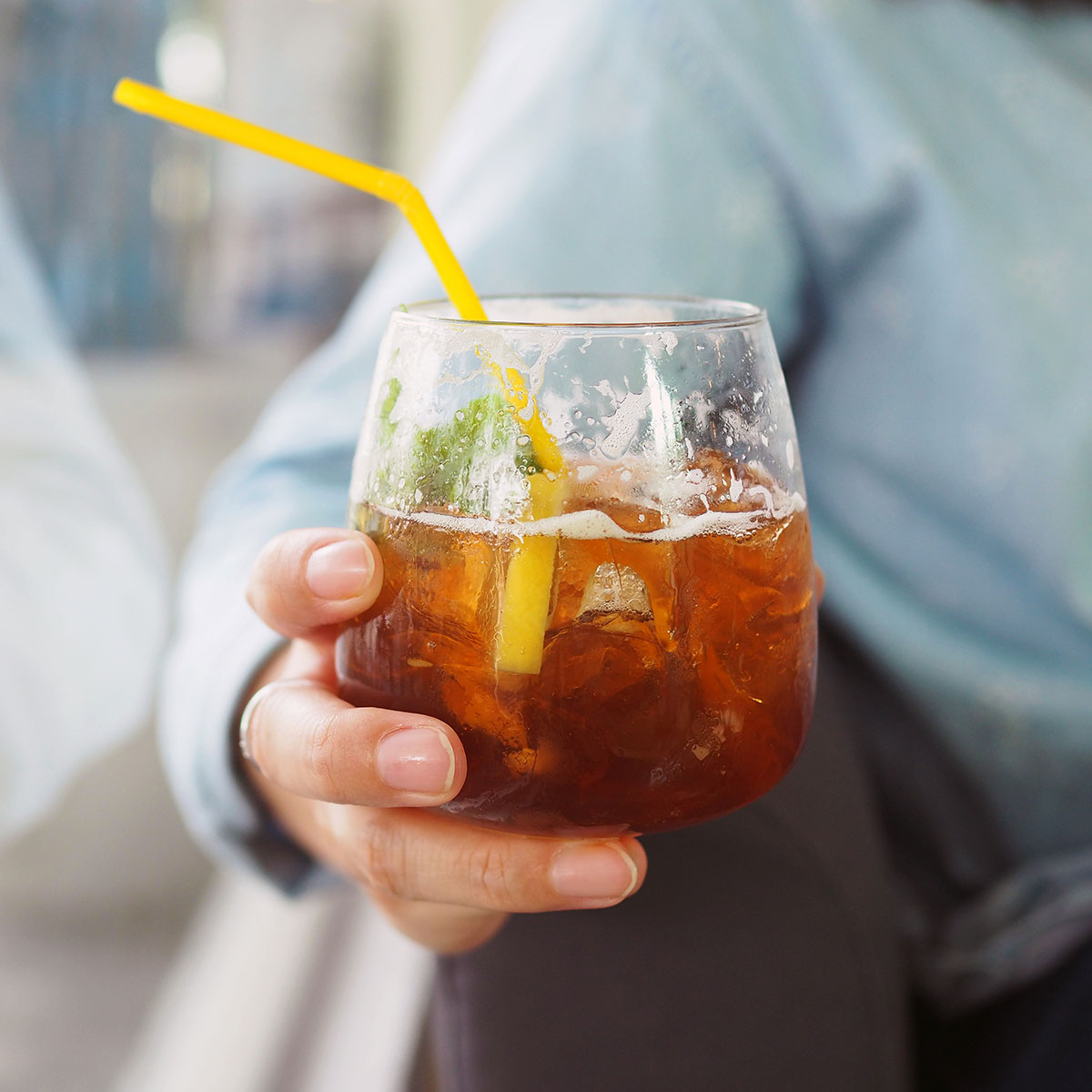 woman holding glass of sweet tea