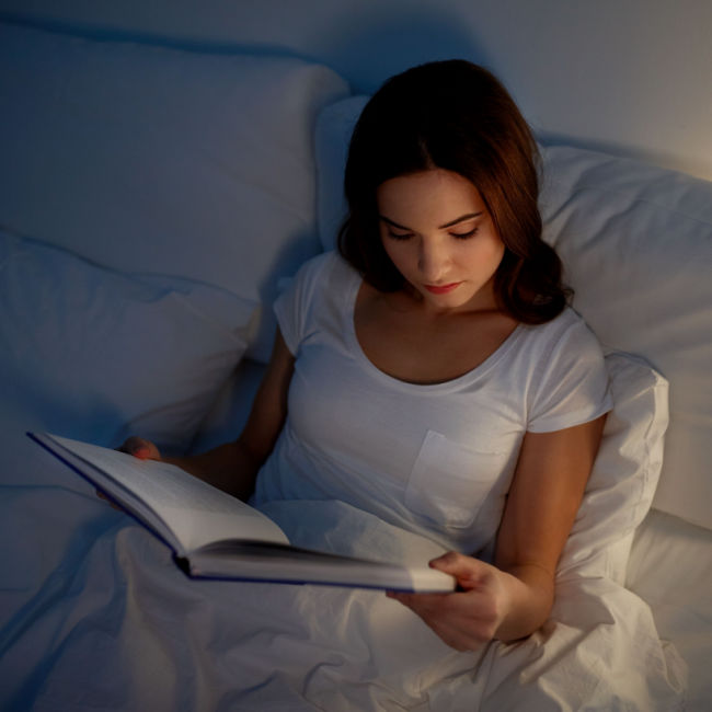 woman reading in bed