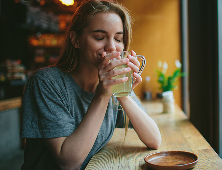 Woman drinking green tea.