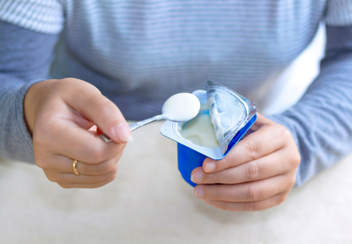 Woman eating yogurt.