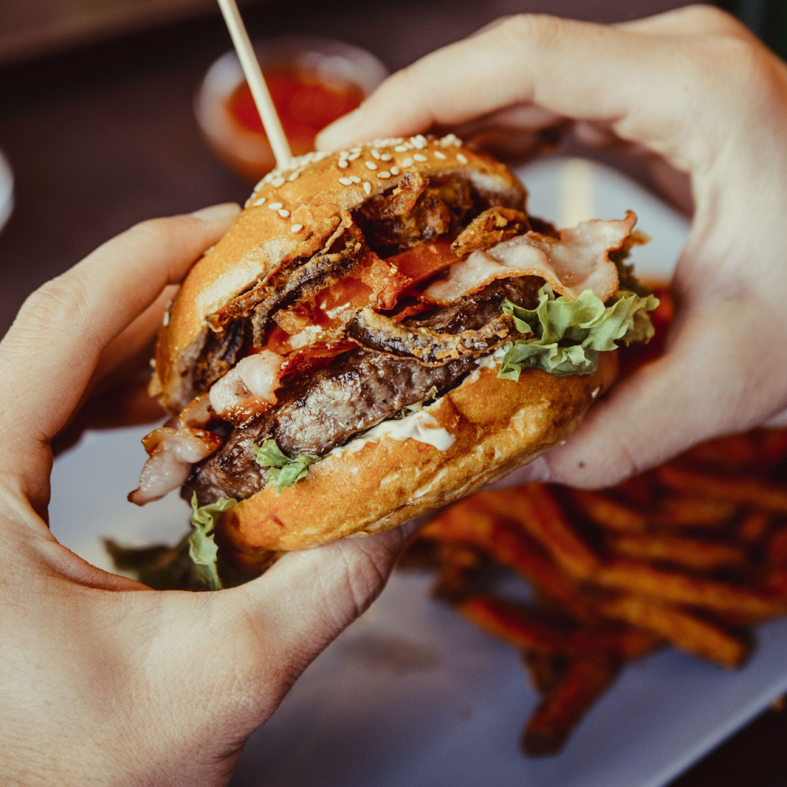 hands holding burger