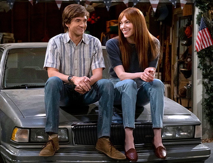 eric foreman and donna sitting on car