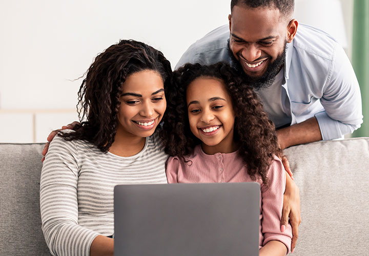Family in front of a laptop