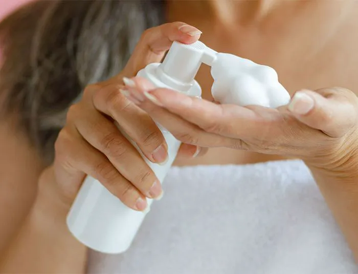 Woman with hair mousse.