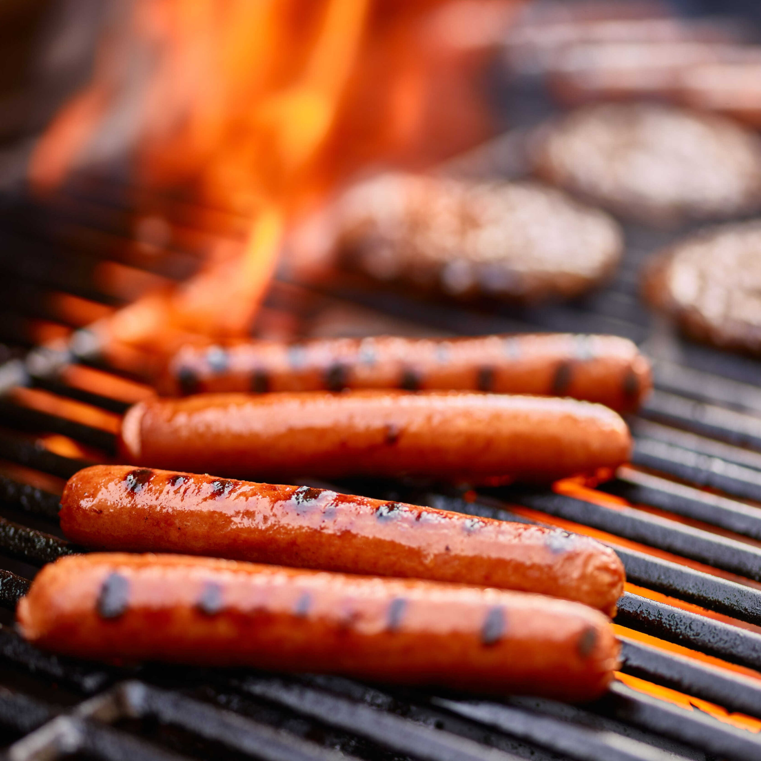 hot dogs and burgers on grill