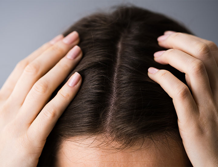 Woman with a middle hair part.