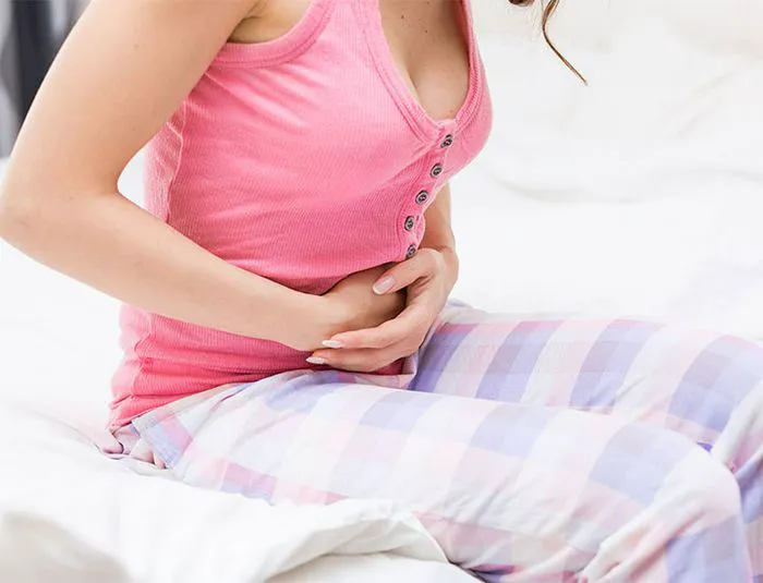 Woman with an upset stomach.