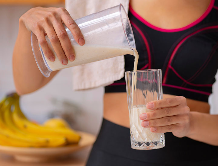 Woman pouring a glass of milk