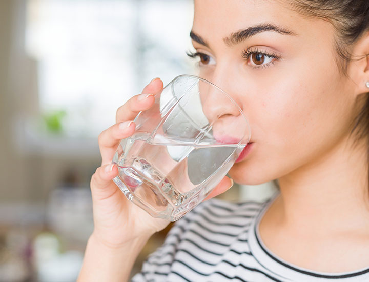 Woman drinking water.