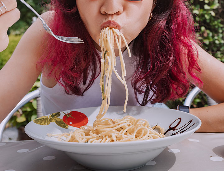 Woman slurping spaghetti.