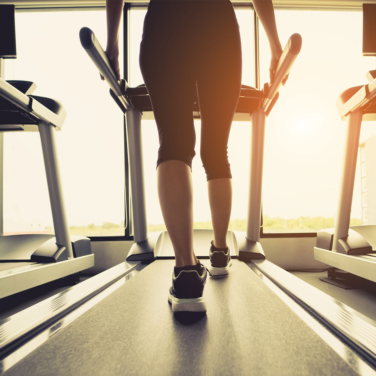woman walking on treadmill at gym
