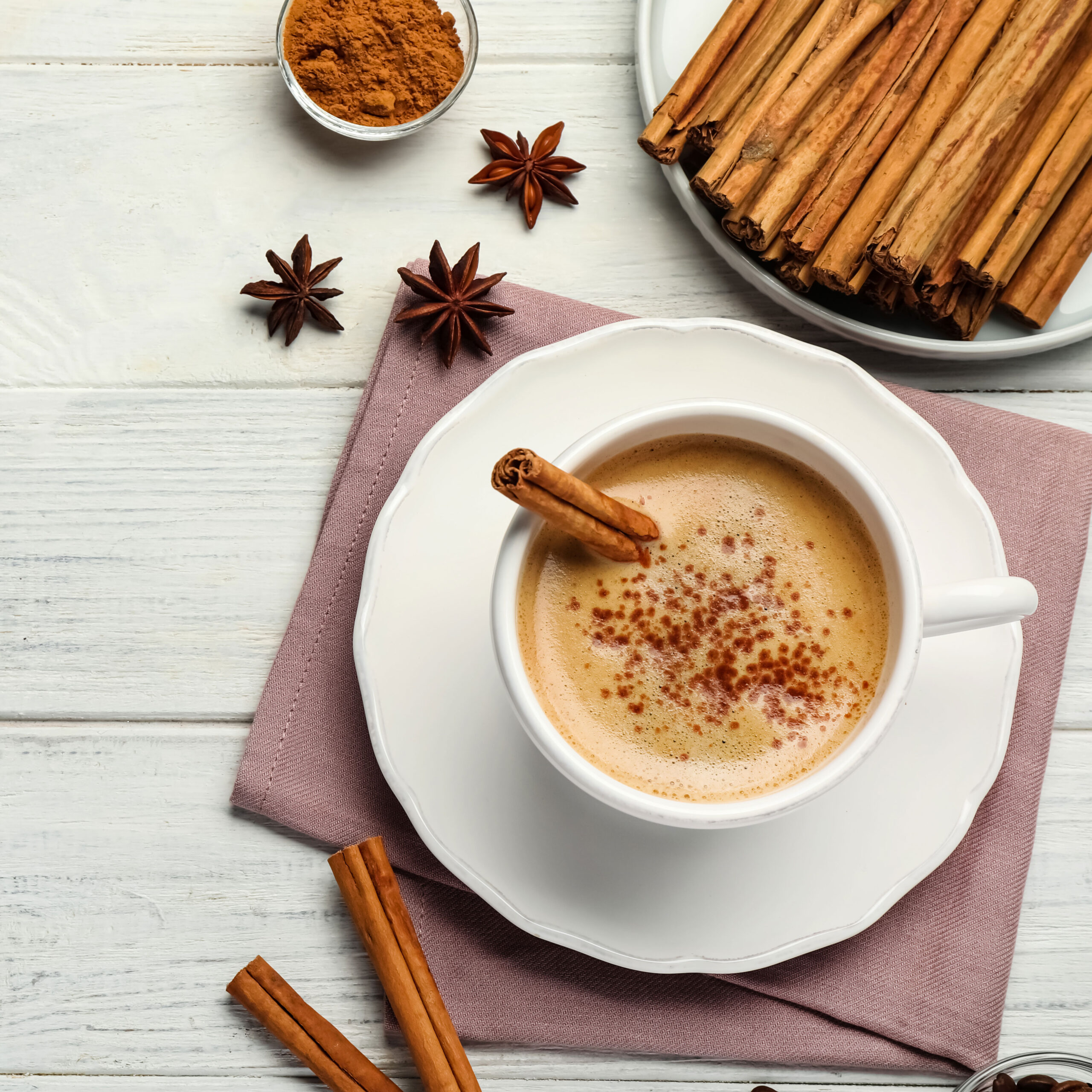 cup of coffee with cinnamon on table