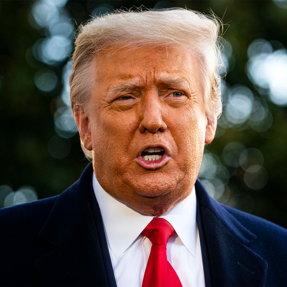 trump close-up yellow hair orange face red tie black suit white shirt