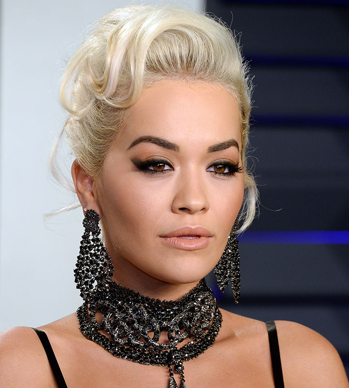 rita ora black necklace choker dangly earrings blonde hair updo nude lipstick cat-eye liner red carpet